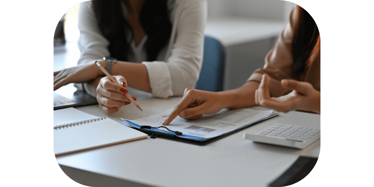 Two people discussing finances at a desk.