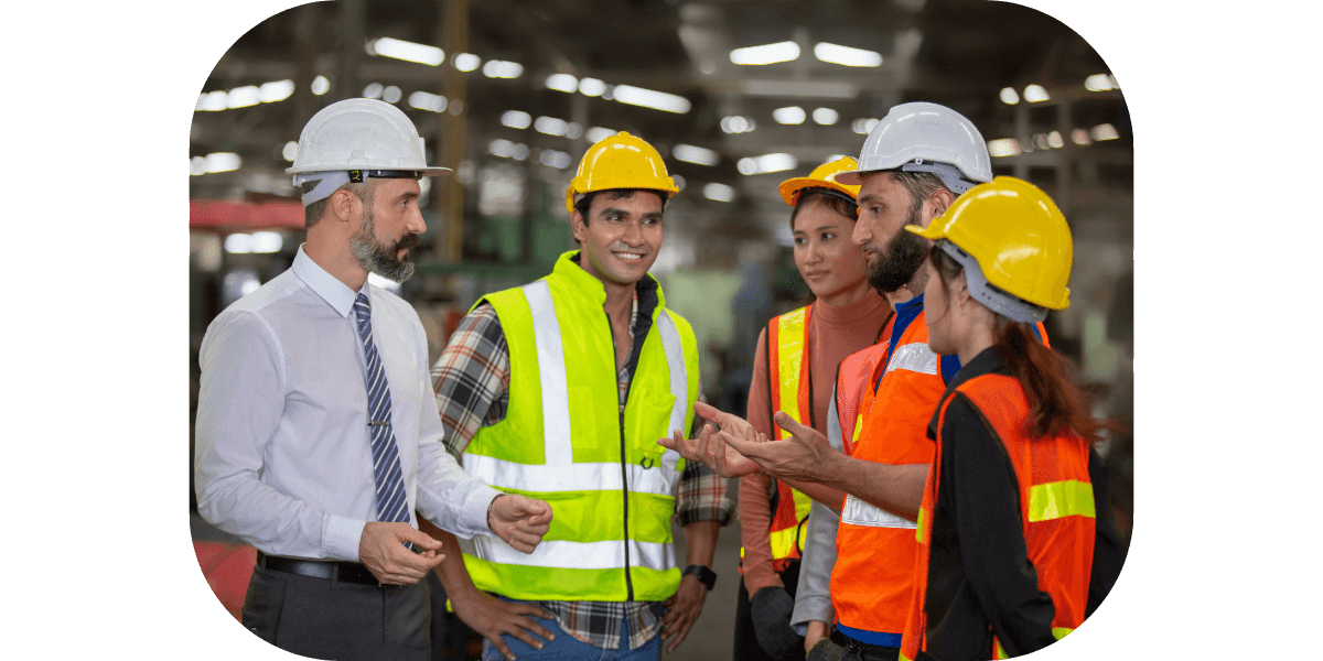 Workers meeting at a power plant to discuss something.